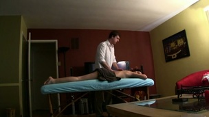 Massuer is stimulating chick's wet crack with vibrator after massage